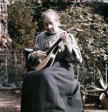 Sarah Angelina Acland autochrome photo; First lady of photography, with her guitar and dog Chum, August 1910 - History of Science Museum