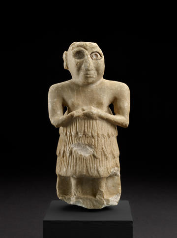 A limestone statue of a male figure