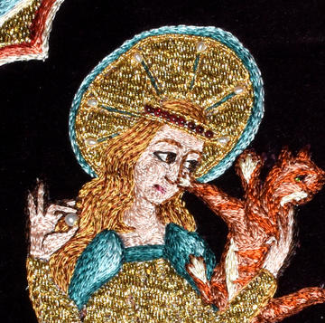 Colourful medieval embroidery of an angel and animal by embroiderer Tanya Bentham