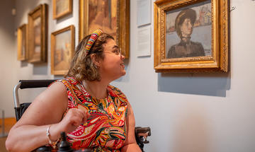 A visitor viewing a painting in the Sickert Gallery at the Ashmolean A visitor viewing a painting in the Sickert Gallery at the Ashmolean