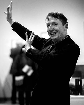 Director Xa Sturgis gesticulating at an Ashmolean event in black and white
