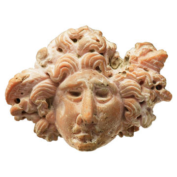 Carved stone in the form of the head of Medusa, EA1993.19 Carved stone in the form of the head of Medusa with snakes for hair