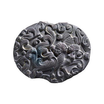 Box lid depicting a kinnara couple (mythic creatures – sometimes half-human and half-bird), EA2013.38 Carved box lid decorated with swirling motifs and two half-bird half-human figures
