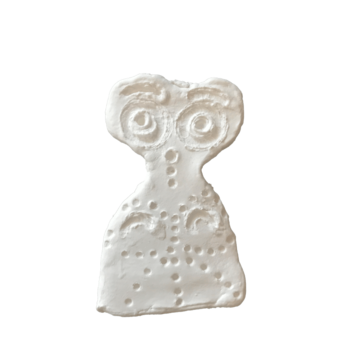 Light coloured stone or clay carving of an Eye idol called Miss Holly