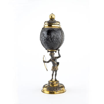 A tall ornate cup and lid made from gold fittings and a painted coconut