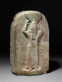 Stone stela of Ashurbanipal: the king is shown with a ritual basket of earth on his head, c.668-655 BCE