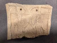Fragment of the upper front of a chariot model, the god Martu facing the goddess Ishtar, c.2350-2150 BCE AN1926_481_chariot_model_ fragment
