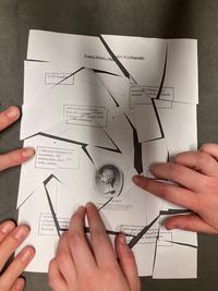 Students reconstructing a cut-up page about Douce; image © Jim Harris Students hands reconstructing a cut-up biography of Francis Douce