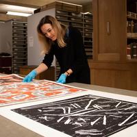 Dr Lena Fritsch looking at A. R Penck's artworks in detail